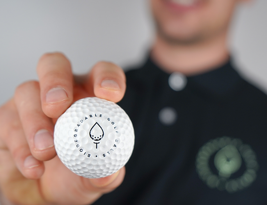Photo of a man holding a Biodegradable Golf Ball