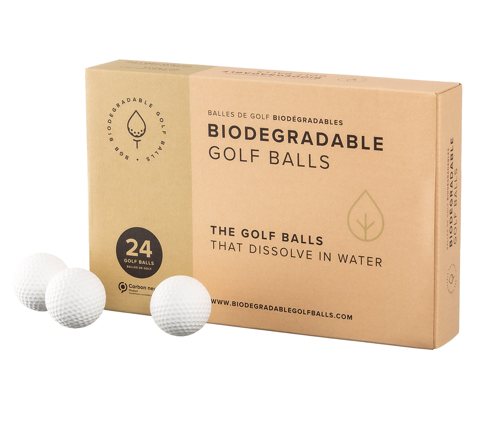 A pack of biodegradable golf balls with 3 golf balls placed in front.
