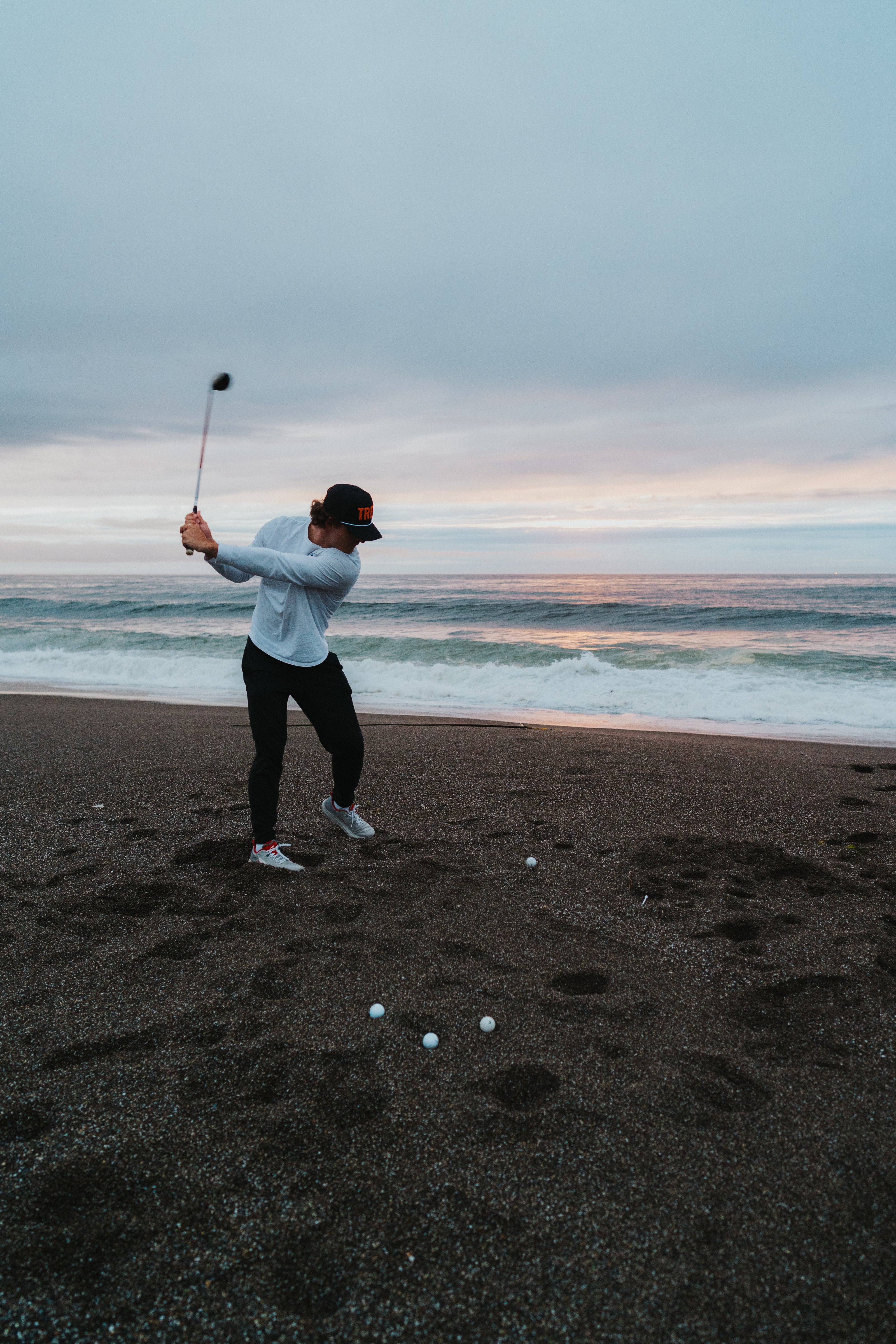 A man hitting biodegradable golf balls into the Pacific Ocean!